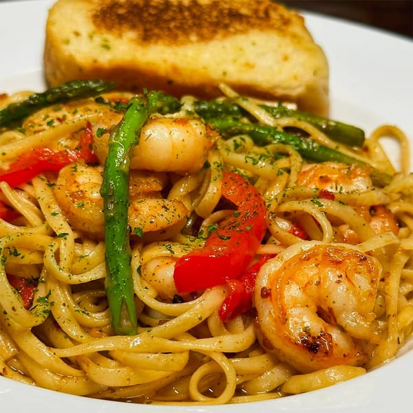 Nico's shrimp scampi with linguine, red peppers, asparagus, and garlic bread.